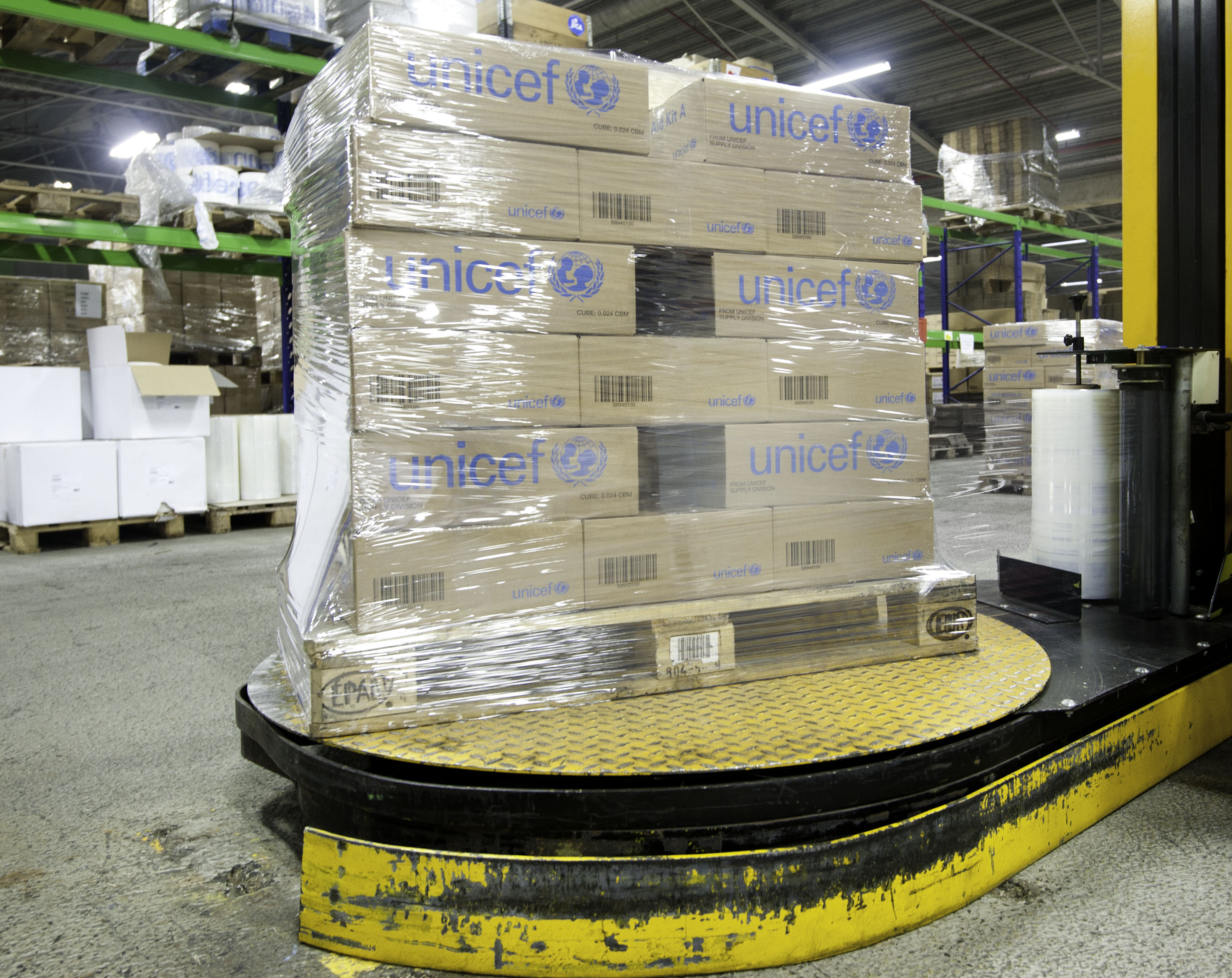 Rotary arm pallet wrapper applying stretch film to a load